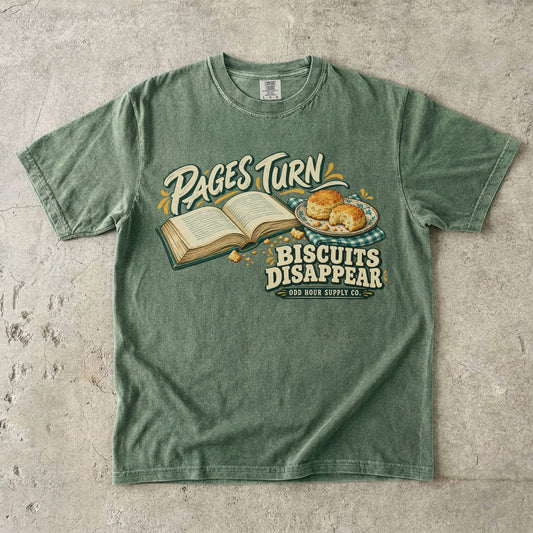 T-Shirt in Moss mit offenem Buch, Gebäck und PAGES TURN BISCUITS DISAPPEAR von Odd Hour Supply Co.