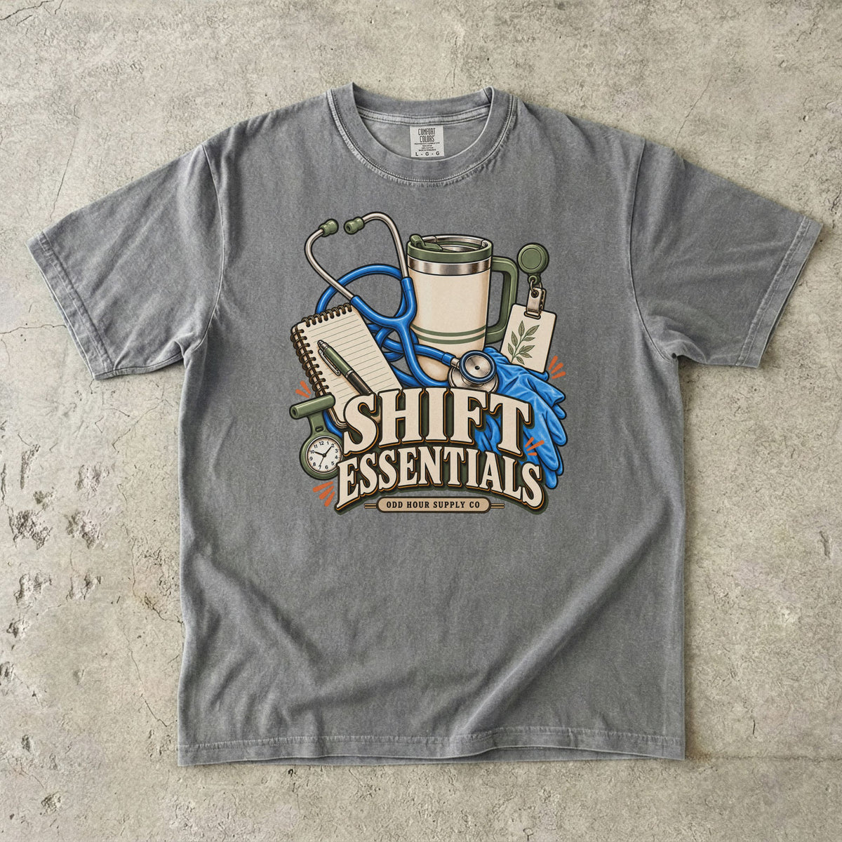 Shift Essentials Pflegeausrüstung-Motiv auf einem Comfort Colors 1717 T-Shirt in Granite