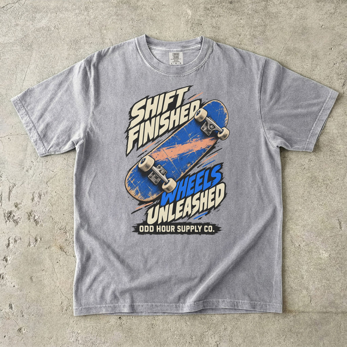 Graues T-Shirt mit blauem Skateboard und SHIFT FINISHED WHEELS UNLEASHED von Odd Hour Supply Co.