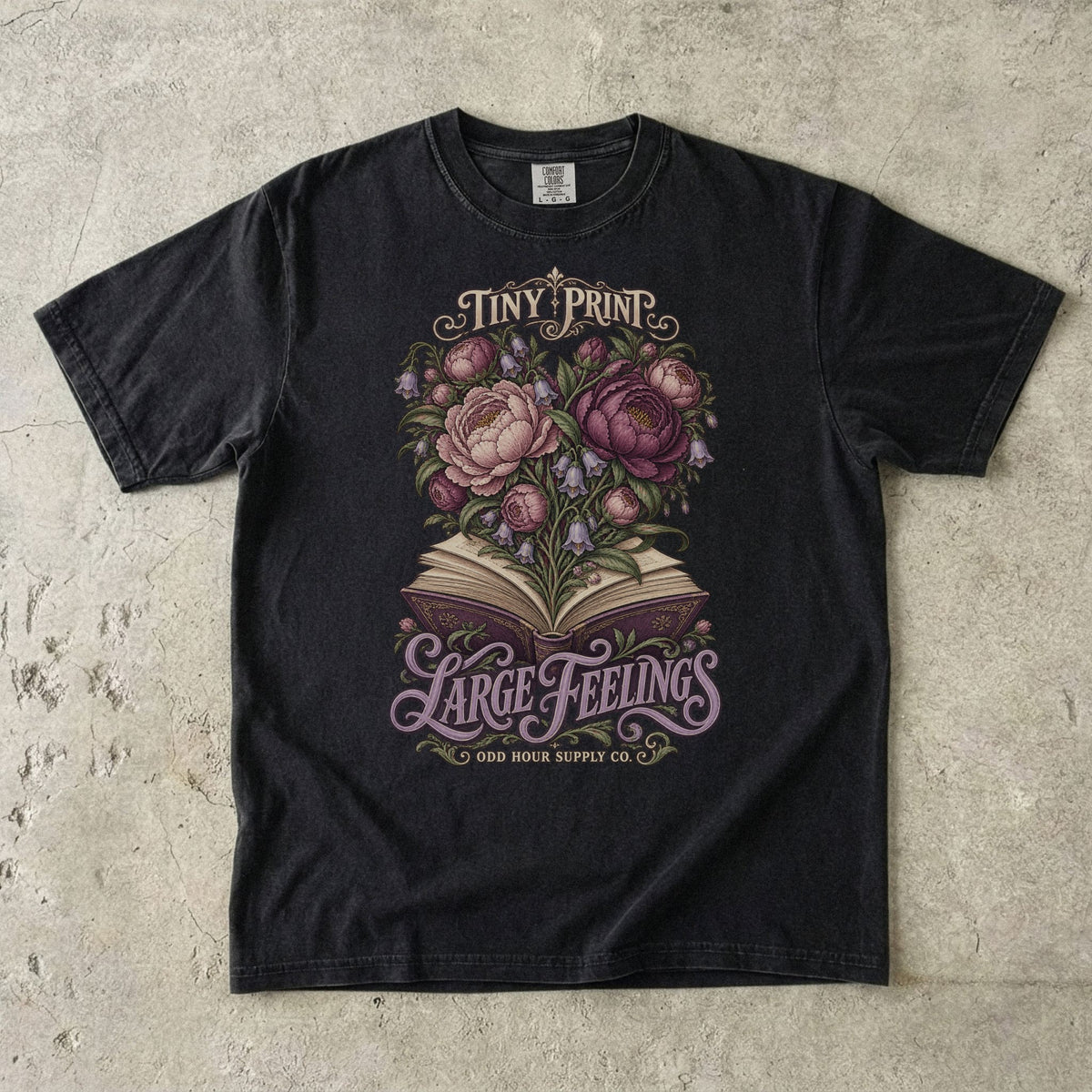 T-Shirt in Black mit Blüten aus einem offenen Buch und TINY PRINT LARGE FEELINGS von Odd Hour Supply Co.