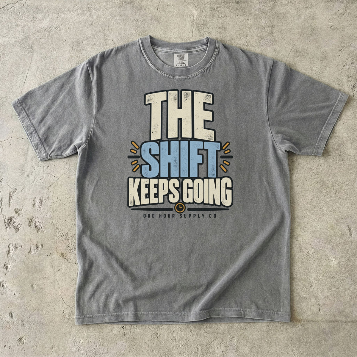 The Shift Keeps Going Typografie auf einem Comfort Colors T-Shirt in Granite